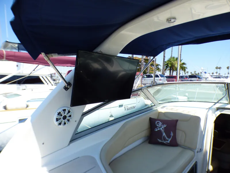 Slide: The Image of 2001 Monterey 302 Cruiser interior with TV, speaker, and anchor-themed pillow. - 9