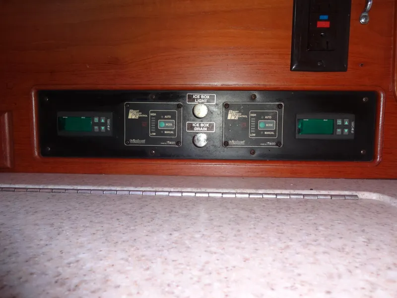 Slide: The Image of Control panel on 2006 Island Packet 440 yacht, featuring digital displays and switches. - 11