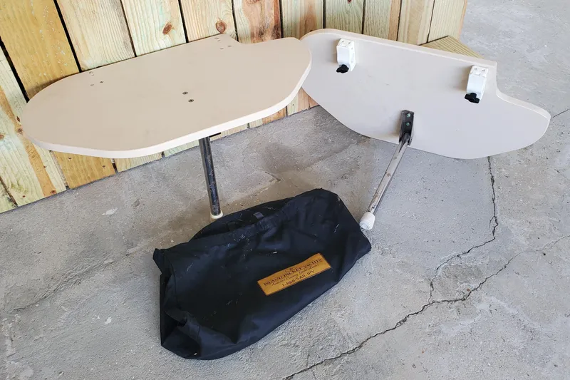 Slide: The Image of 2006 Island Packet 440 boat tables and storage bag on concrete floor. - 168