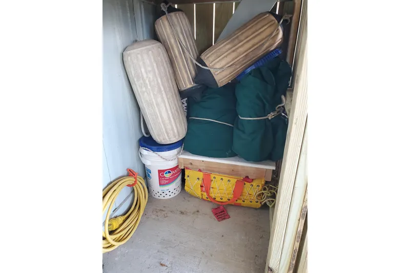 Slide: The Image of Storage compartment with boat fenders, buckets, and ropes on a 2006 Island Packet 440. - 170