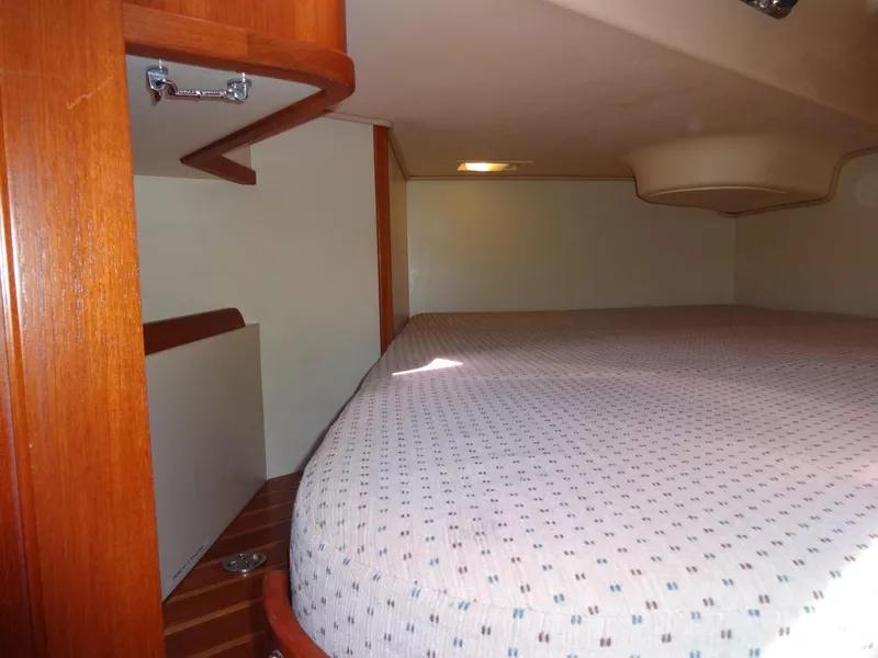 Slide: The Image of Interior cabin of 2006 Island Packet 440 sailboat with wooden accents and cozy bed. - 26