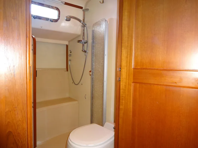 Slide: The Image of Bathroom interior of 2006 Island Packet 440 yacht with shower and wooden cabinetry. - 31