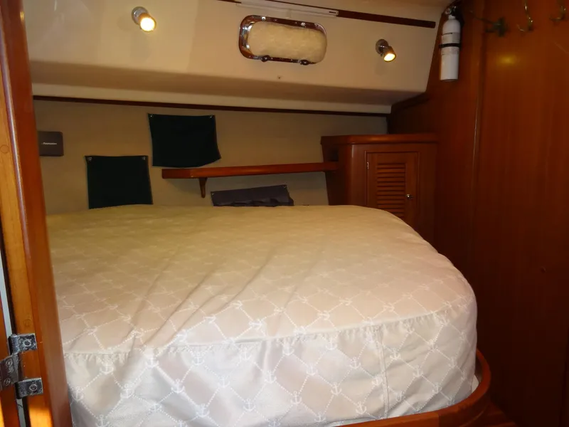 Slide: The Image of Cozy cabin interior of 2006 Island Packet 440 sailboat with wooden furnishings. - 49