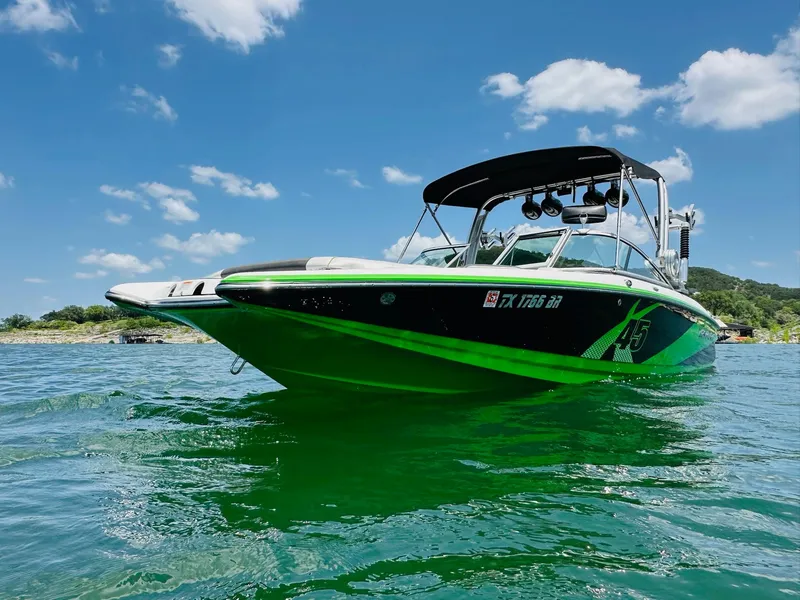 Slide: The Image of 2012 MasterCraft X-45 boat on clear water under a bright blue sky. - 1