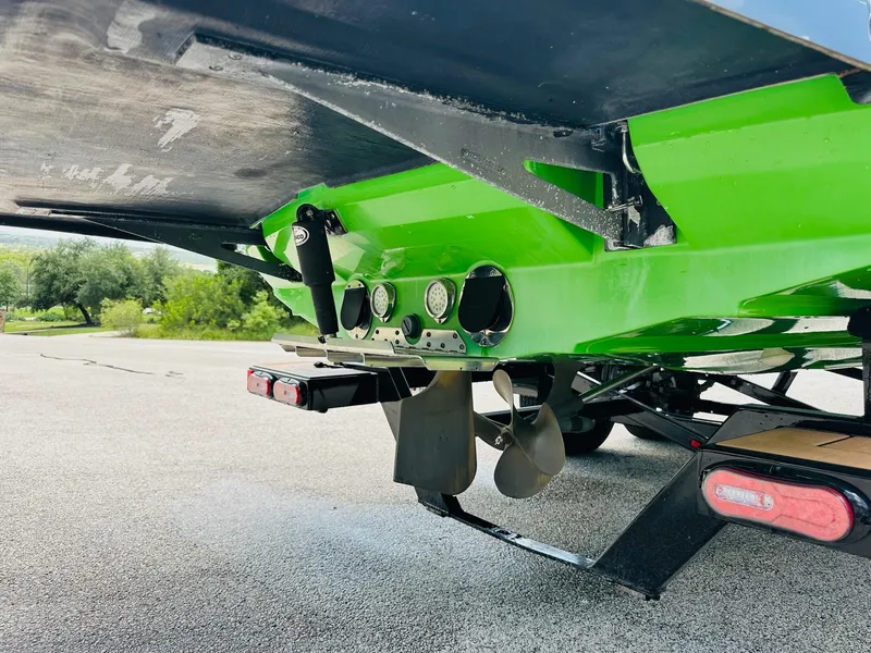 Slide: The Image of 2012 MasterCraft X-45 boat underside with propeller and vibrant green hull. - 12