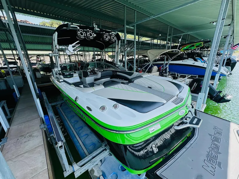 Slide: The Image of 2012 MasterCraft X-45 boat in dock, featuring sleek design and vibrant green accents. - 14