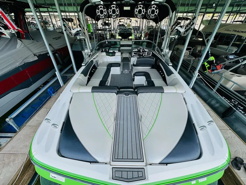 Slide: The Image of 2012 MasterCraft X-45 boat interior with sleek seating and modern design in a marina. - 15