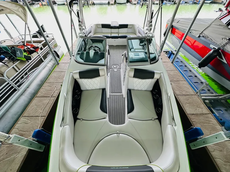 Slide: The Image of 2012 MasterCraft X-45 boat interior with sleek seating and modern design in a marina. - 17