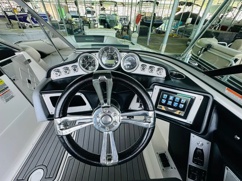 Slide: The Image of 2012 MasterCraft X-45 boat dashboard with steering wheel and digital display. - 19