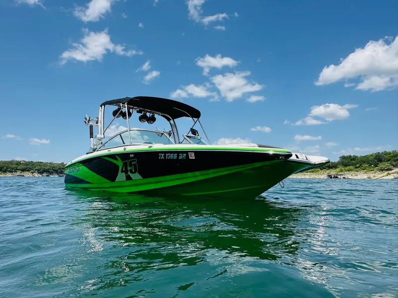 Slide: The Image of 2012 MasterCraft X-45 boat on water under blue sky with clouds. - 5