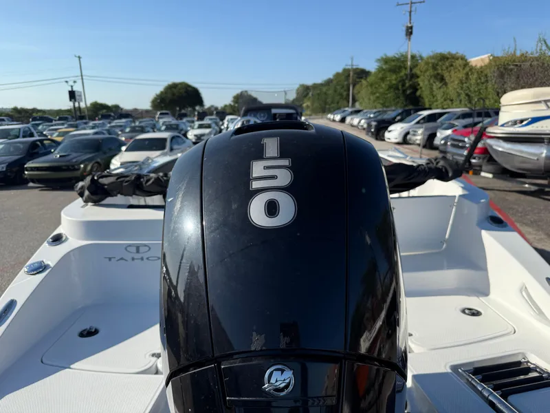 Slide: The Image of 2020 Tahoe 2150 CC boat with a 150 HP engine in a parking lot. - 11