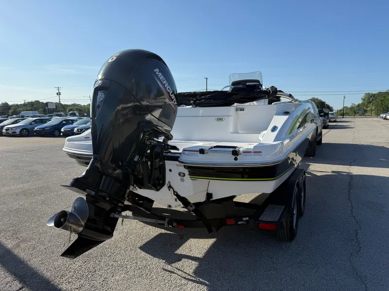 Slide: The Image of 2020 Tahoe 2150 CC boat with Mercury outboard motor on a trailer in a parking lot. - 12