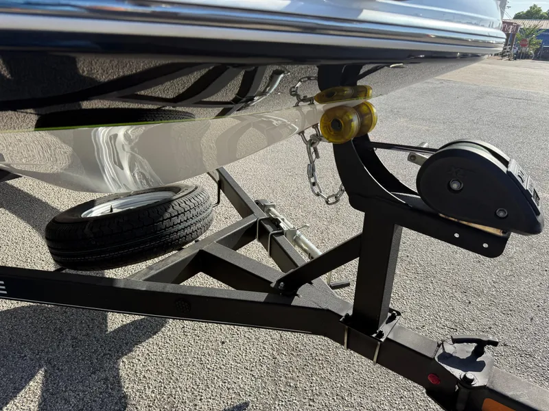 Slide: The Image of Trailer hitch and wheel of 2020 Tahoe 2150 CC boat on pavement. - 15