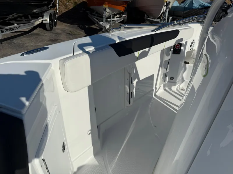 Slide: The Image of 2020 Tahoe 2150 CC boat interior with white seating and storage compartments. - 26