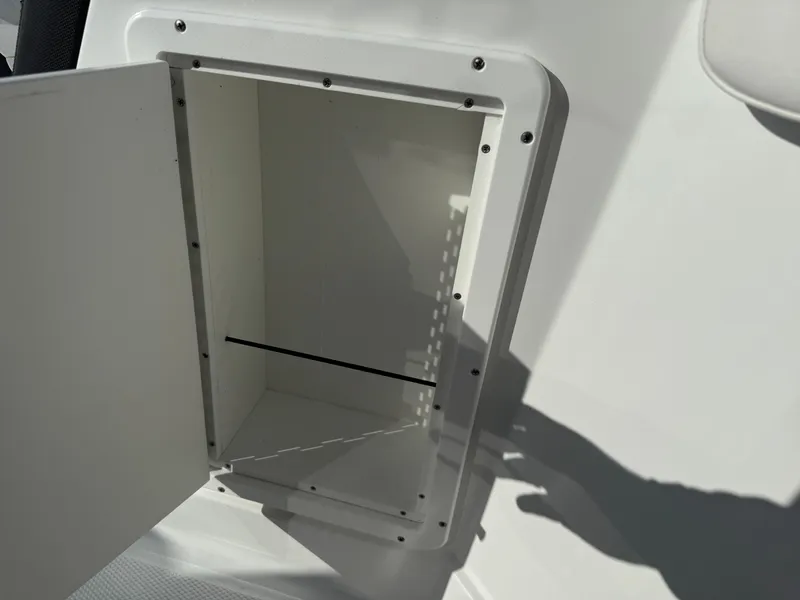 Slide: The Image of Open storage compartment on 2020 Tahoe 2150 CC boat, showing interior space. - 27
