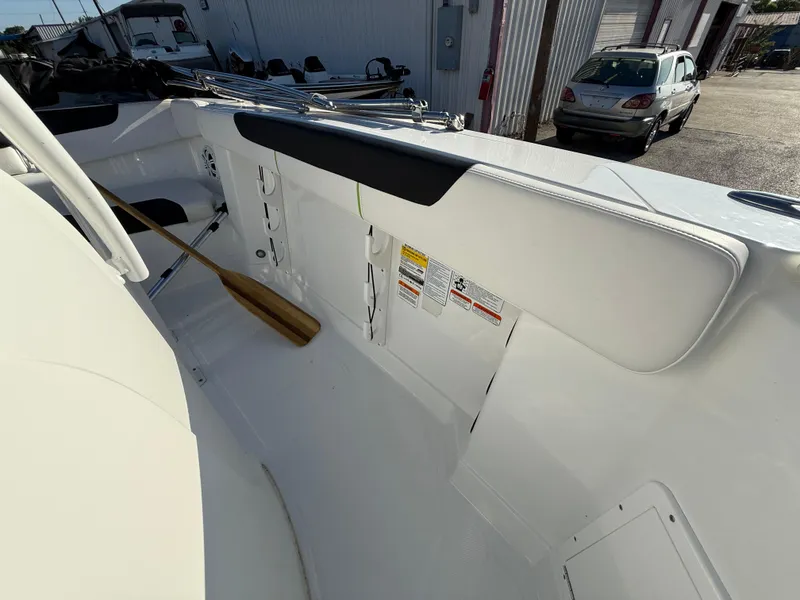 Slide: The Image of 2020 Tahoe 2150 CC boat interior with paddle and safety labels. - 29