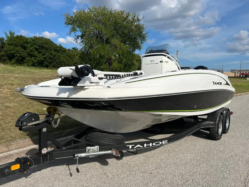 Slide: The Image of 2020 Tahoe 2150 CC boat on trailer, parked outdoors under a blue sky. - 3