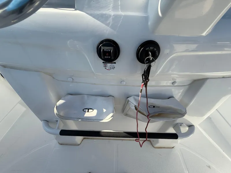 Slide: The Image of 2020 Tahoe 2150 CC boat dashboard with ignition keys and storage compartments. - 33