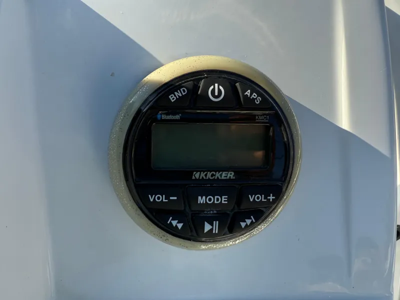 Slide: The Image of Close-up of a Kicker audio control panel on a 2020 Tahoe 2150 CC boat. - 35