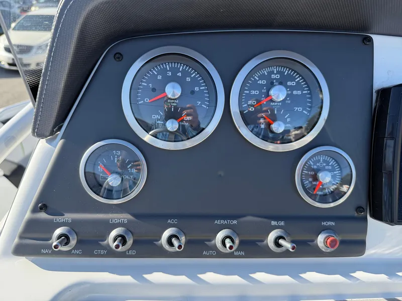 Slide: The Image of Dashboard of 2020 Tahoe 2150 CC boat with gauges and switches. - 36