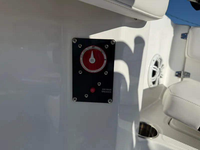 Slide: The Image of 2020 Tahoe 2150 CC boat interior with main breaker switch and seating. - 37