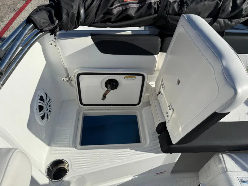 Slide: The Image of 2020 Tahoe 2150 CC boat interior with open storage compartment and speaker. - 38