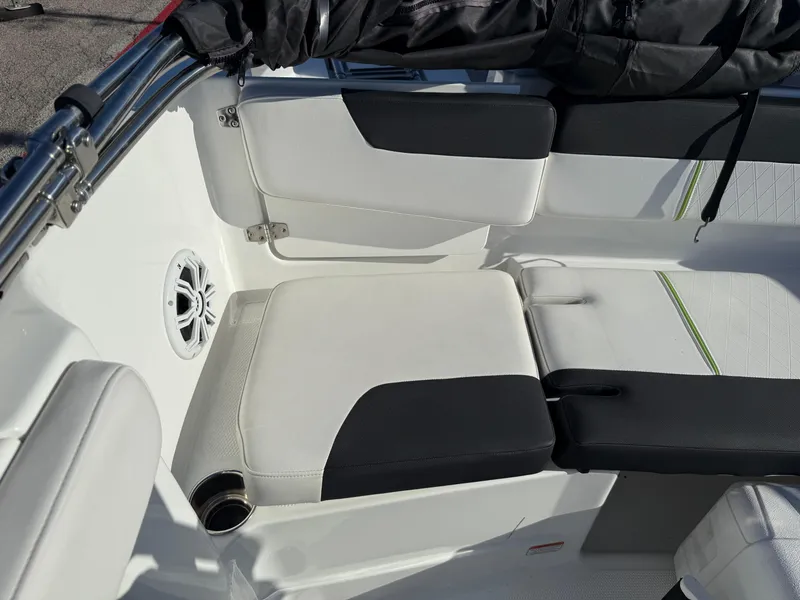 Slide: The Image of 2020 Tahoe 2150 CC boat interior with white and black seating, speaker, and storage. - 39
