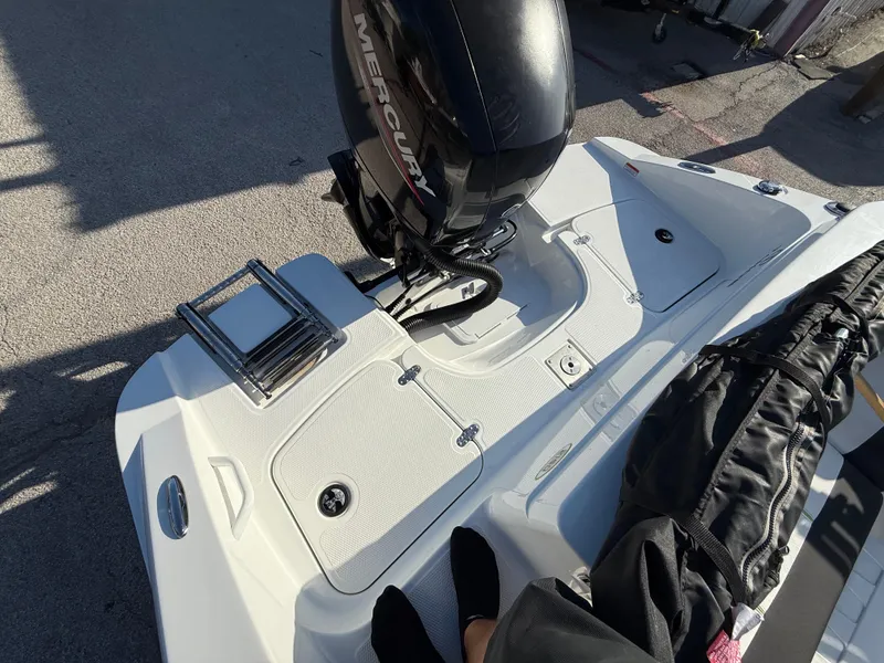 Slide: The Image of 2020 Tahoe 2150 CC boat with Mercury engine, featuring a swim platform and ladder. - 41