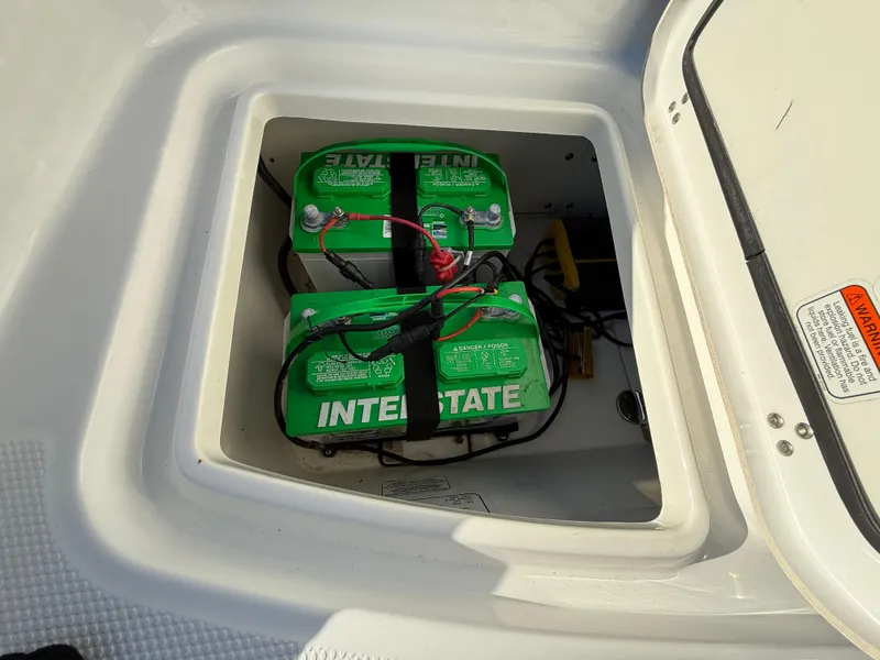 Slide: The Image of Batteries installed in a 2020 Tahoe 2150 CC boat compartment. - 42