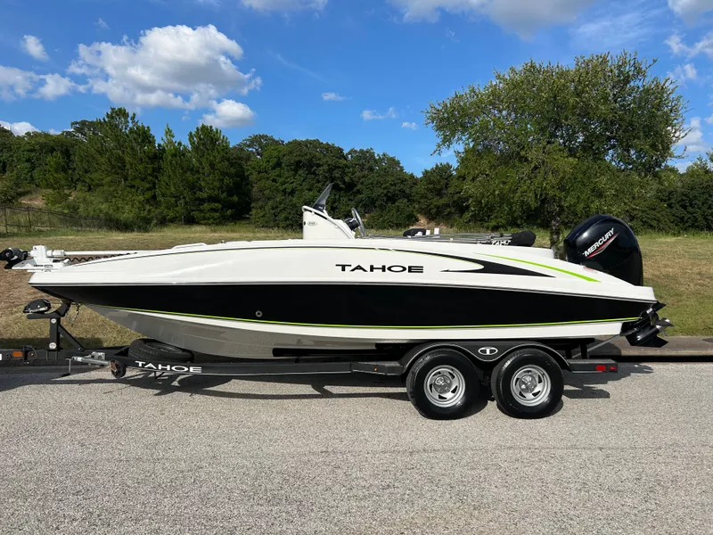 Slide: The Image of 2020 Tahoe 2150 CC boat on trailer, parked outdoors under a clear sky. - 43