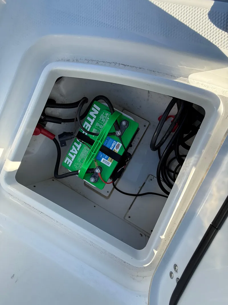 Slide: The Image of Battery compartment of a 2020 Tahoe 2150 CC boat, featuring Interstate batteries. - 46