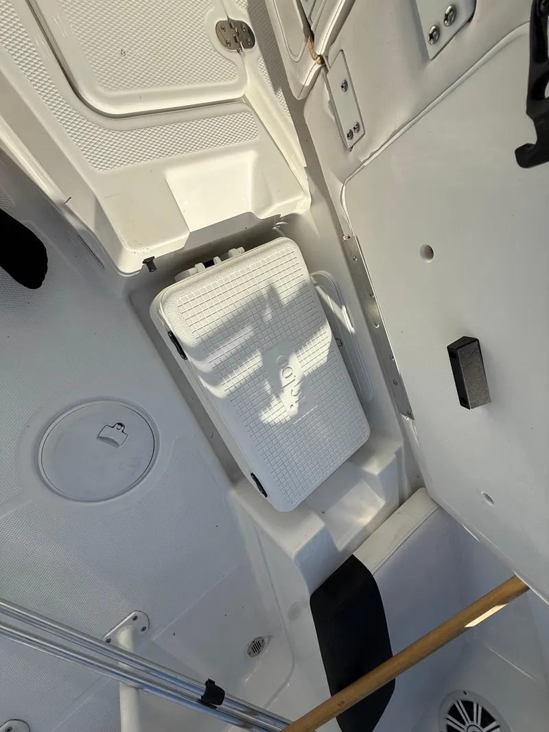 Slide: The Image of 2020 Tahoe 2150 CC boat interior with storage compartments and seating. - 48