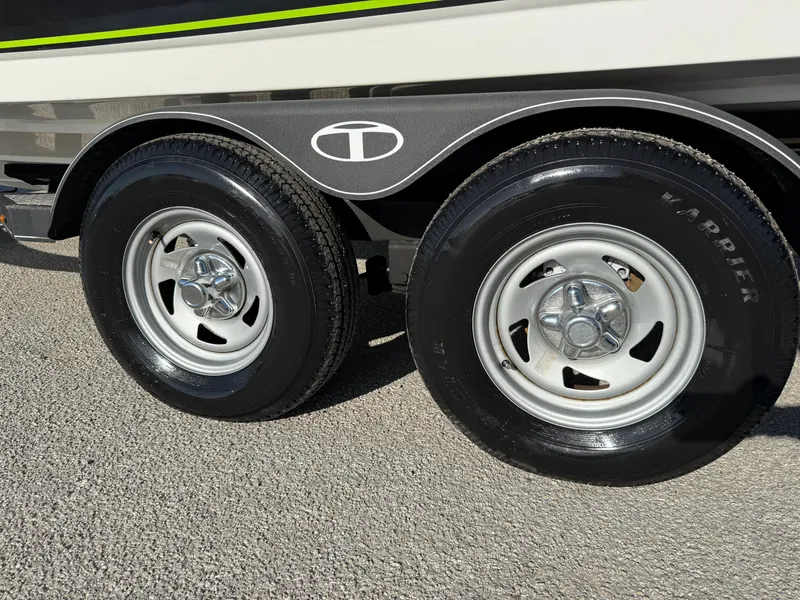 Slide: The Image of Trailer wheels of a 2020 Tahoe 2150 CC boat on pavement. - 49