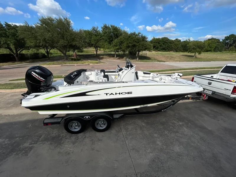 Slide: The Image of 2020 Tahoe 2150 CC boat on trailer, parked beside a white truck. - 5