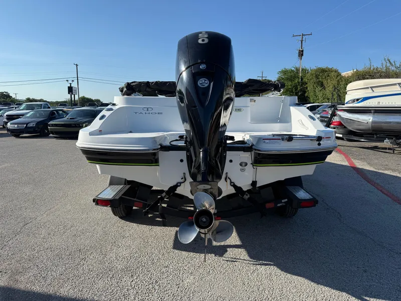 Slide: The Image of 2020 Tahoe 2150 CC boat on trailer, rear view with outboard motor, parked outdoors. - 7