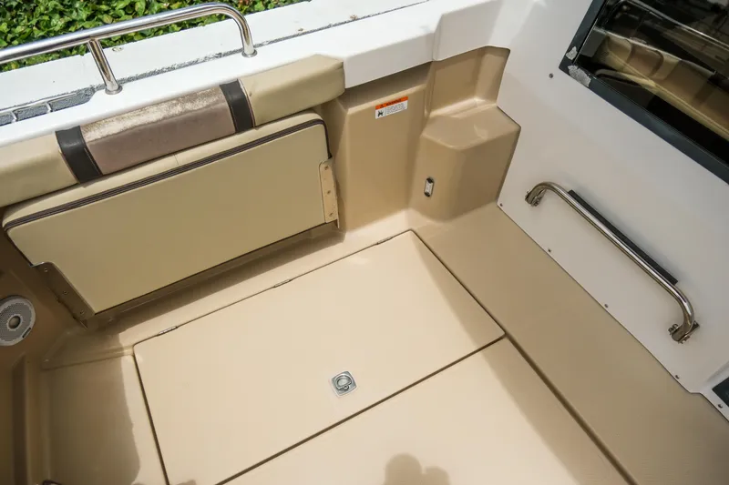 Slide: The Image of 2018 Ranger Tugs R-23 boat interior with beige seating and stainless steel railing. - 14