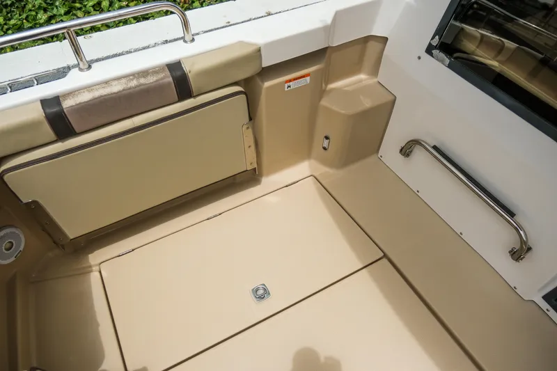 Slide: The Image of 2018 Ranger Tugs R-23 boat interior with beige seating and stainless steel handrail. - 15