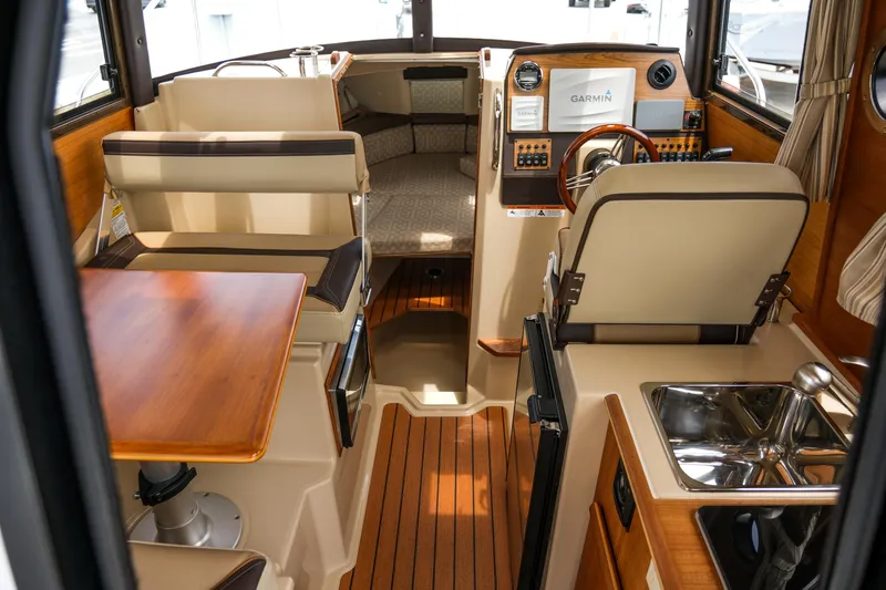 Slide: The Image of Interior of 2018 Ranger Tugs R-23 boat with seating, table, and navigation equipment. - 19