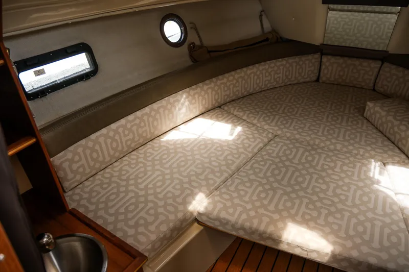 Slide: The Image of 2018 Ranger Tugs R-23 cabin interior with patterned cushions and wooden accents. - 24