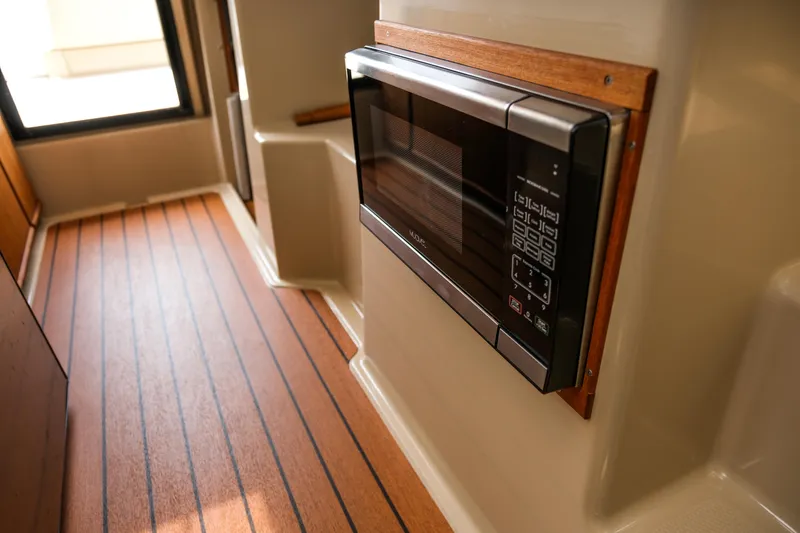 Slide: The Image of Interior of 2018 Ranger Tugs R-23 with built-in microwave and wood flooring. - 28