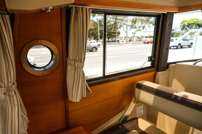 Slide: The Image of Interior view of 2018 Ranger Tugs R-23 boat with porthole and window. - 31