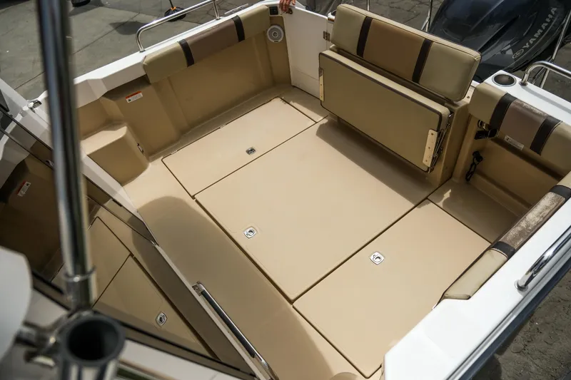 Slide: The Image of 2018 Ranger Tugs R-23 boat interior with beige seating and storage compartments. - 34