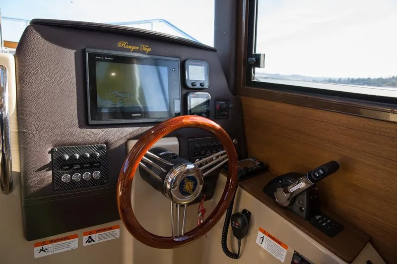 Slide: The Image of Manufacturer Provided Image: 2018 Ranger Tugs R-23 helm with wooden steering wheel and navigation controls. - 36