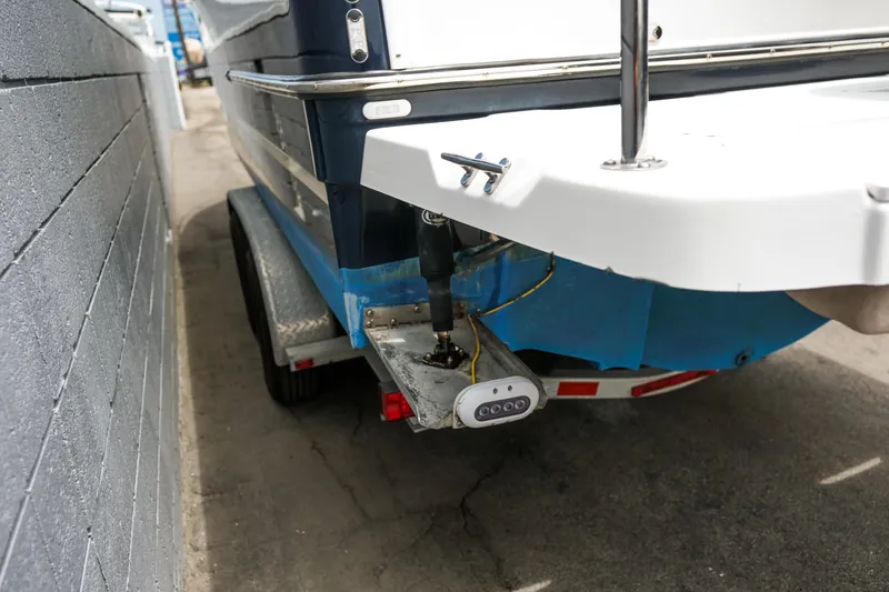 Slide: The Image of 2018 Ranger Tugs R-23 boat on trailer, rear view, parked beside a wall. - 8