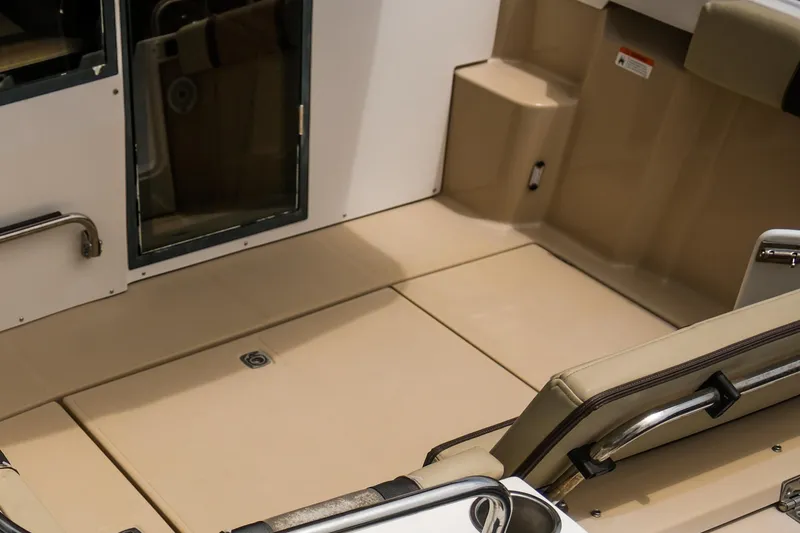 Slide: The Image of 2018 Ranger Tugs R-23 boat interior with beige seating and flooring. - 9