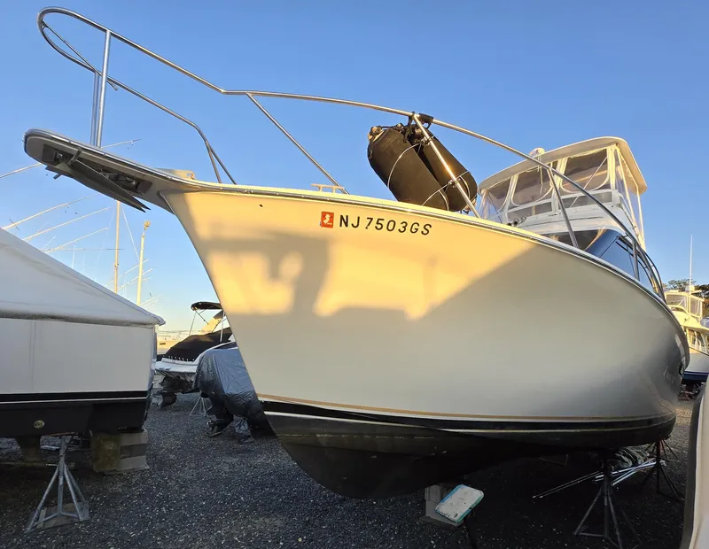 Slide: The Image of 1988 Ocean 35 Super Sport boat on dry dock, registration NJ7503GS, under clear blue sky. - 11