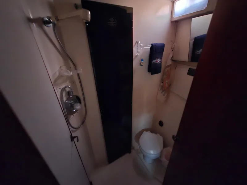 Slide: The Image of Bathroom interior of 1988 Ocean 35 Super Sport yacht, featuring shower and toilet. - 12