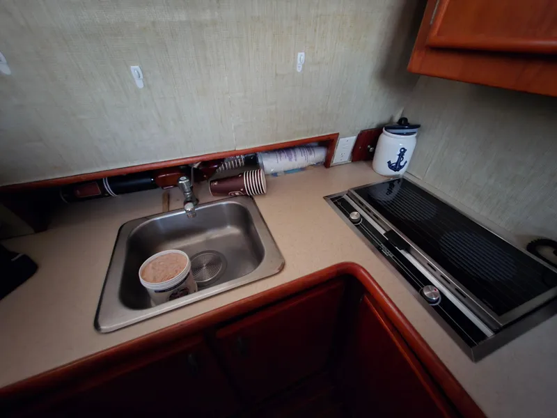 Slide: The Image of 1988 Ocean 35 Super Sport kitchen with sink, stove, and nautical decor. - 15