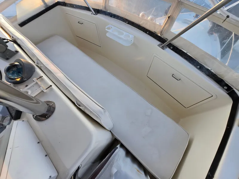Slide: The Image of 1988 Ocean 35 Super Sport boat interior with seating and storage compartments. - 18