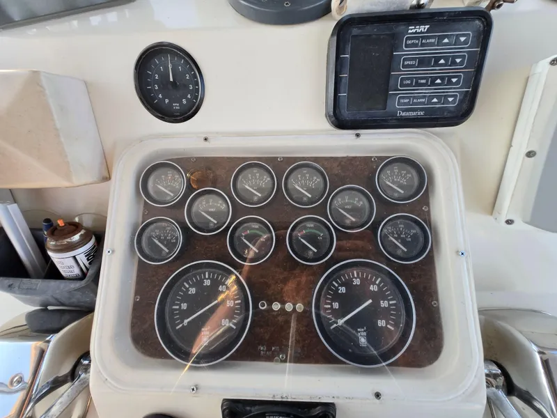 Slide: The Image of Dashboard of a 1988 Ocean 35 Super Sport boat with gauges and controls. - 20
